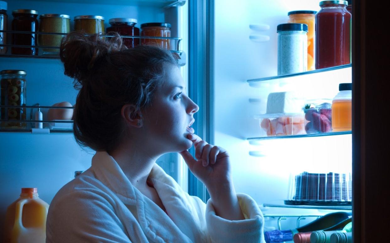 Stock image of a woman looking into a fridge -  YinYang/ E+