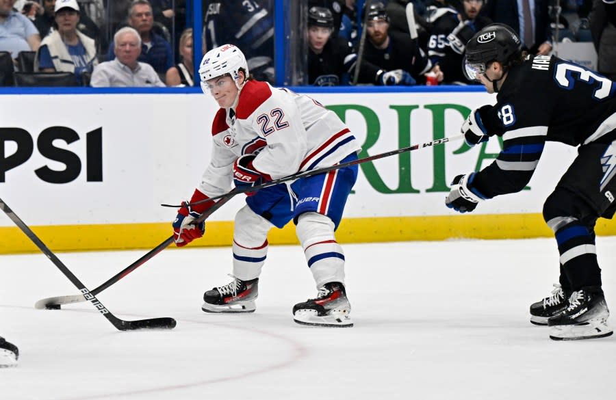 Montreal Canadiens right wing Cole Caufield (22) handles the puck against Tampa Bay Lightning left wing Brandon Hagel (38) during the first period of an NHL hockey game Saturday, March 2, 2024, in Tampa, Fla. (AP Photo/Jason Behnken)
