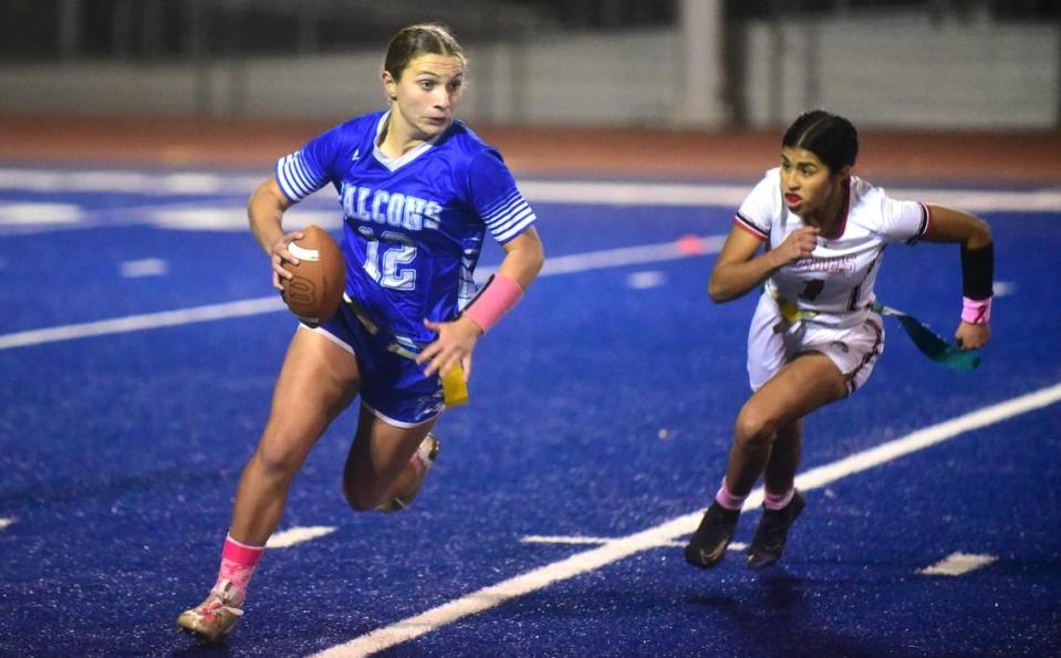 Atwater High School quarterback Madison Hiler (12) runs while being chased by Ceres’ Marissa Renteria (1) during a playoff game on Thursday, Oct. 26, 2023 in Atwater, Calif.