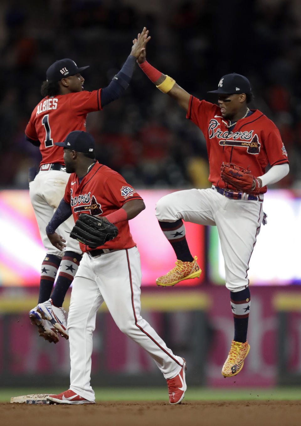 Atlanta Braves' Ronald Acuna Jr., right, celebrates with Ozzie Albies at the end of a baseball game against the Miami Marlins, Friday, July 2, 2021, in Atlanta. (AP Photo/Ben Margot)