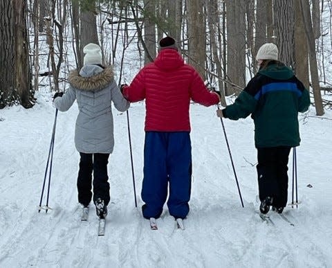 Special Outdoor Leisure Opportunities volunteers guide their cross-country ski student in winter 2023 at Rum Village Park in South Bend.