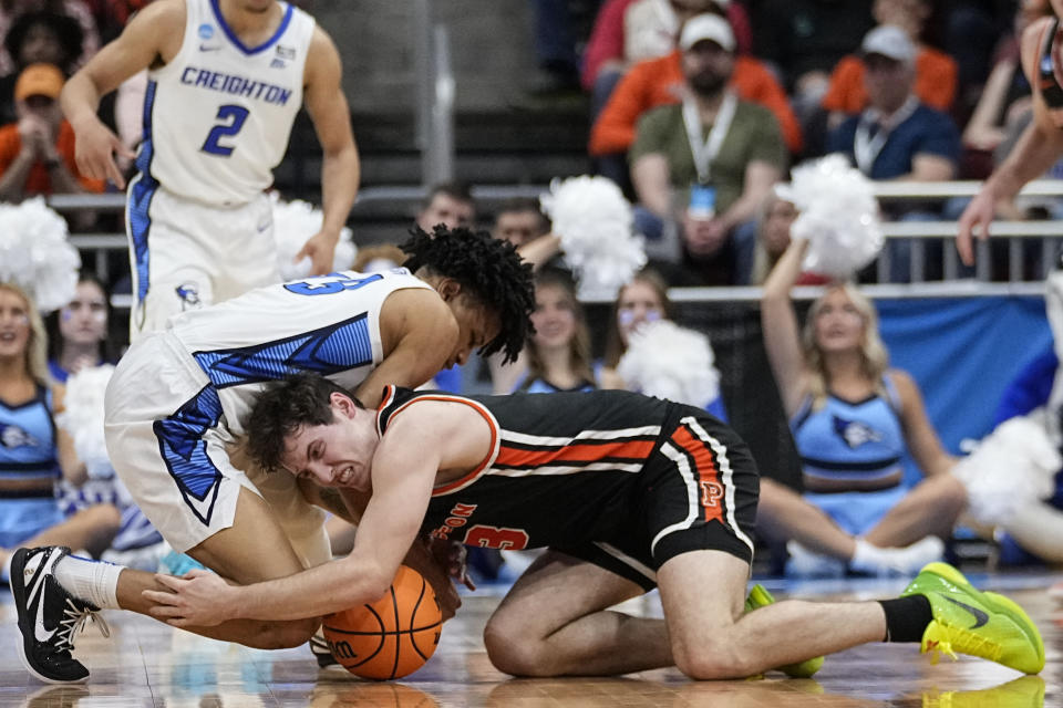 Creighton guard Trey Alexander (23) and Princeton guard Ryan Langborg (3) vie for a loose ball in the second half of a Sweet 16 round college basketball game in the South Regional of the NCAA Tournament, Friday, March 24, 2023, in Louisville, Ky. (AP Photo/John Bazemore)