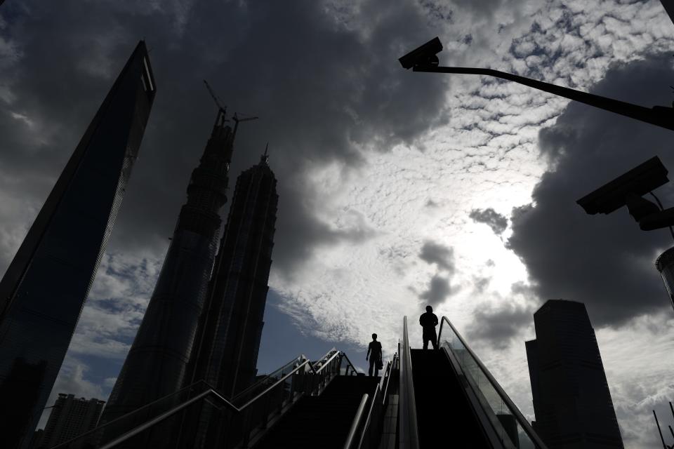 Pedestrians use a flight of stairs and an escalator located next to each other, at the financial district of Pudong in Shanghai September 23, 2013. China's cabinet detailed plans last week to speed construction of urban infrastructure projects, in the latest move in Beijing's plan to boost domestic demand by swelling the ranks of city dwellers. REUTER/Aly Song)