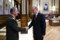 Turkey's President Recep Tayyip Erdogan (R) shakes hands with Chief of General Staff Hulusi Akarl at the Presidential Complex in Ankara on July 29, 2016