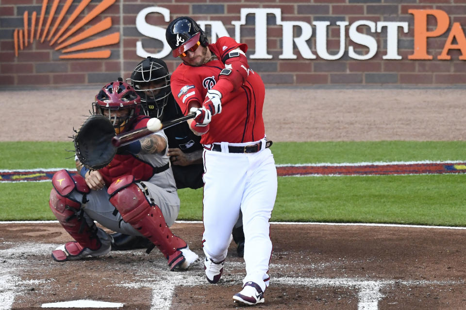 Atlanta Braves third baseman Josh Donaldson (20) follows through after hiting an RBI single against the St. Louis Cardinals in the first inning during Game 2 of a best-of-five National League Division Series, Friday, Oct. 4, 2019, in Atlanta. (AP Photo/Scott Cunningham)