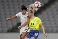 United States' Carli Lloyd, left, and Sweden's Amanda Ilestedt, right, go for a header during a women's soccer match at the 2020 Summer Olympics, Wednesday, July 21, 2021, in Tokyo. (AP Photo/Ricardo Mazalan)