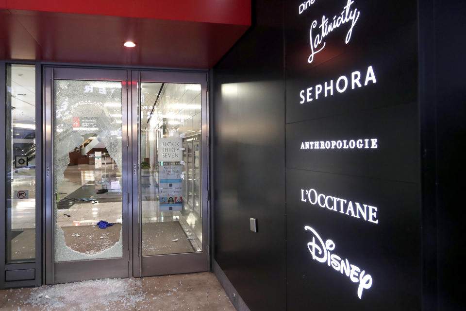 A door to the Block 37 retail building is shattered Monday, Aug. 10, in Chicago. (Photo: AP Photo/Charles Rex Arbogast)