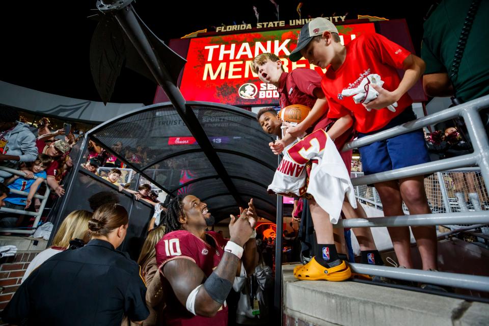 Florida State's DJ Lundy (10) signs autographs after the team's NCAA college football game against North Alabama, Saturday, Nov. 18, 2023, in Tallahassee, Fla. (AP Photo/Colin Hackley)