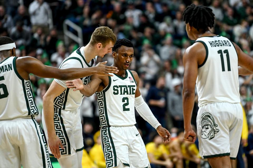 Michigan State's Tyson Walker, center, celebrates with teammates after drawing a Michigan foul on a shot during the second half on Tuesday, Jan. 30, 2024, at the Breslin Center in East Lansing.