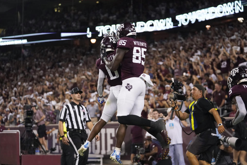 Texas A&M tight end Jalen Wydermyer (85) celebrates with wide receiver Ainias Smith (0) after scoring a touchdown agent Alabama during the first half of an NCAA college football game Saturday, Oct. 9, 2021, in College Station, Texas. (AP Photo/Sam Craft)