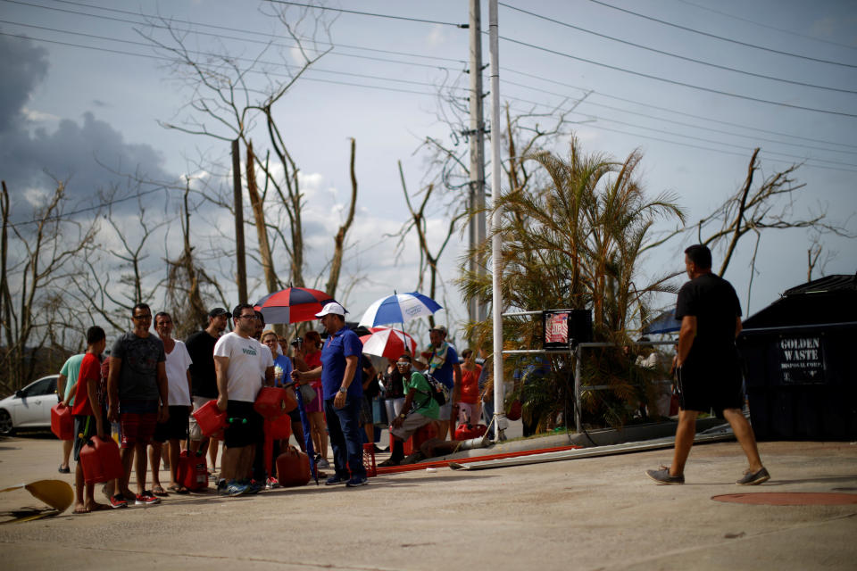 People queue to fill containers with gasoline at&nbsp;a gas station after the area was hit by Hurricane Maria in Toa Baja, Puerto Rico. (Photo: Carlos Garcia Rawlins / Reuters)