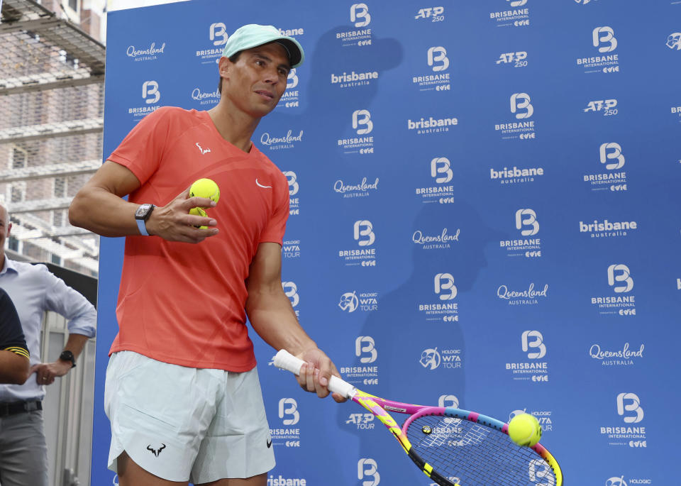 Rafael Nadal of Spain hits a ball into the crowd during a public appearance in the Queen Street Mall ahead of the Brisbane International tennis tournament in Brisbane, Australia, Friday, Dec. 29, 2023. (AP Photo/Tertius Pickard)