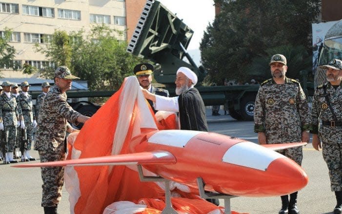 A handout picture released by the Iranian Army office on September 1, 2019, shows Brigadier-General Alireza Sabahifard (C), commander of the Army Air Defence force, unveiling the new drone dubbed 