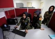 Second Lieutenant Roshan Gul, 22 (L), First Lieutenant Nelofar Frotan, 23 (C), and Second Lieutenant Morsal Afshar, 22 (R), work at the human resources office in the Ministry of Defence in Kabul, Afghanistan October 31, 2016. REUTERS/Mohammad Ismail