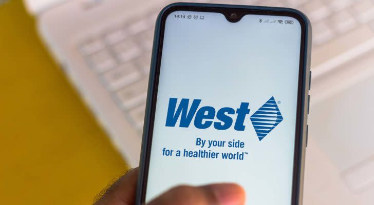 The West Pharmaceutical Services (WST) logo is displayed on a smartphone screen.