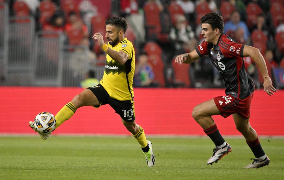 Sep 18, 2024; Toronto, Ontario, CAN; Columbus Crew forward Diego Rossi (10) controls the ball ahead of Toronto FC midfielder Raoul Petretta (28) in the first half at BMO Field. Mandatory Credit: Dan Hamilton-Imagn Images