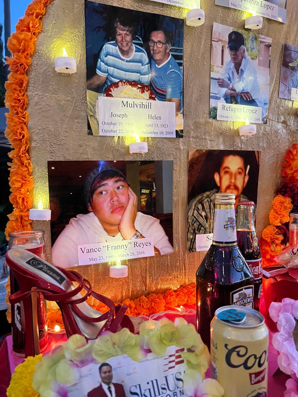 Photos of dead family members are displayed alongside "ofrendas," or offerings," including beer, at the Día de Los Muertos celebration at the Hollywood Forever Cemetery in Los Angeles on Saturday, Oct. 28, 2023.