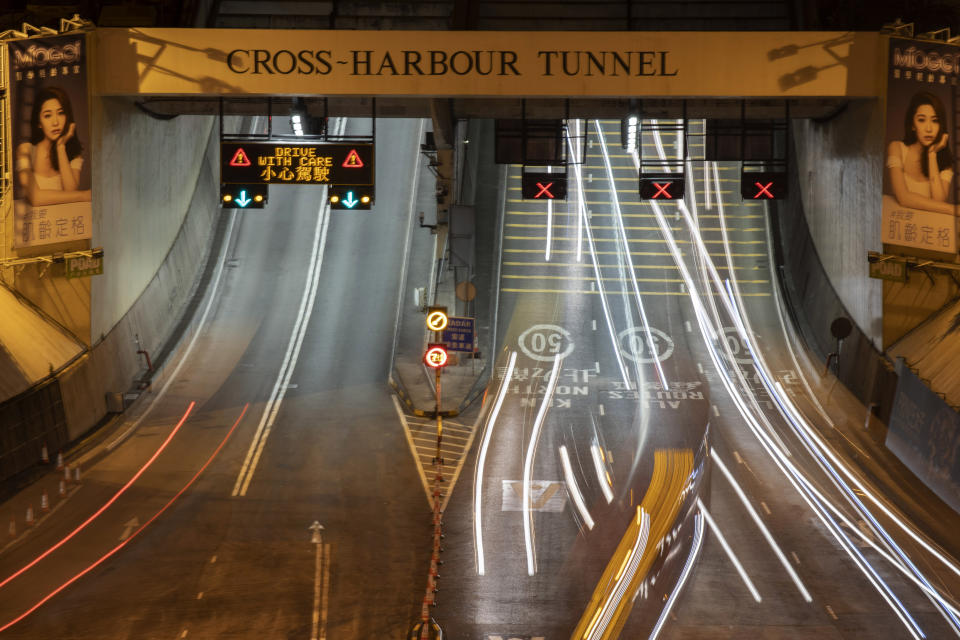 Traffic flows through the Cross-Harbor Tunnel which reopens in Hong Kong on Wednesday, Nov. 27, 2019. Closed by protesters who took over the neighboring Hong Kong Polytechnic University, the tunnel reopens after authorities repaired the damages caused. (AP Photo/Ng Han Guan)