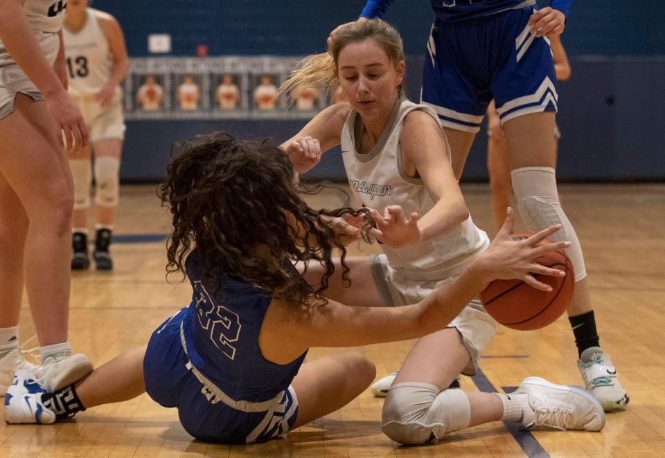 Holmdel Alexandra Loucopoulos and Mansquan Georgia Heine battle for a loose ball in second half action.  Manasquan Girls Basketball defeat Holmdel 62-59  in Shore Conference Quarterfinal game in Middletown, NJ on February 19, 2022. 