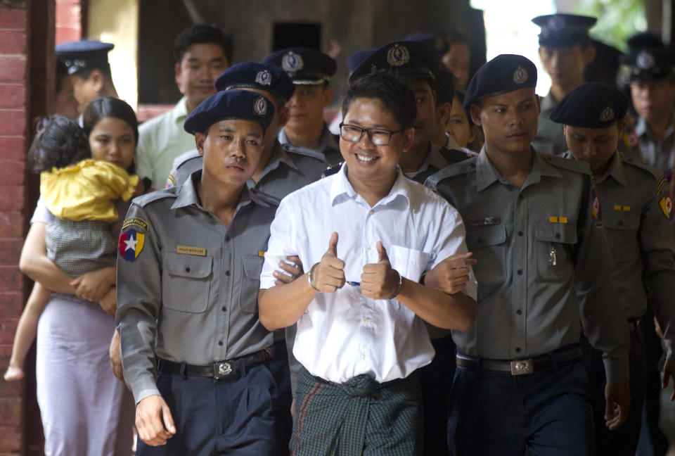 Reuters journalist Wa Lone, center, is escorted by polices upon arrival at the court Monday, Sept. 3, 2018, in Yangon, Myanmar. A Myanmar court sentenced two Reuters journalists, Wa Lone and Kyaw Soe Oo, to seven years in prison Monday for illegal possession of official documents, a ruling that comes as international criticism mounts over the military's alleged human rights abuses against Rohingya Muslims. (AP Photo/Thein Zaw)