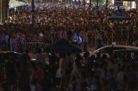 Chinese policemen monitor the crowd near the bund in Shanghai, Wednesday, July 31, 2024. (AP Photo/Ng Han Guan)