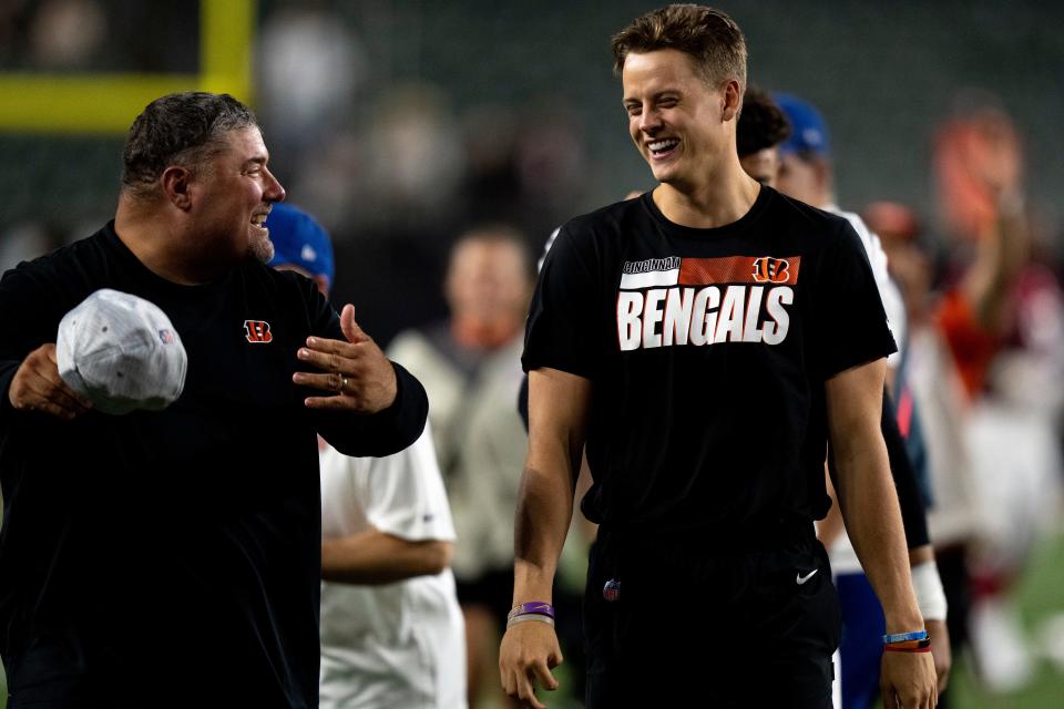 Aug 12, 2022; Cincinnati, Ohio, USA; Cincinnati Bengals quarterback Joe Burrow (9) smiles with Cincinnati Bengals linebacker coach James Bettcher after the NFL preseason game between the Cincinnati Bengals and the Arizona Cardinals at Paycor Stadium. Mandatory Credit: Albert Cesare-USA TODAY Sports