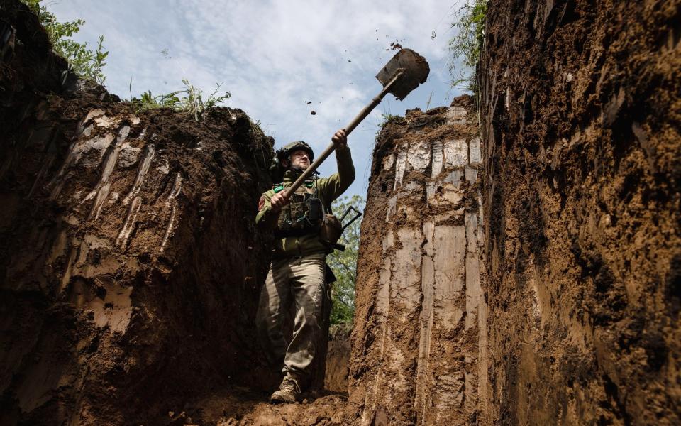 A Ukrainian soldier digs defensive trenches near Kostyantynivka, Ukraine - TYLER HICKS/NYTNS / Redux / eyevine