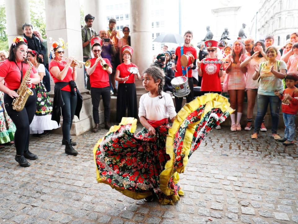 20 August 2022: A young girl dances in Belfast City Centre during the first Mela Carnival, in which participants from more than 20 different cultura groups don traditional costumes to celebrate Northern Ireland’s cultural diversity (PA)
