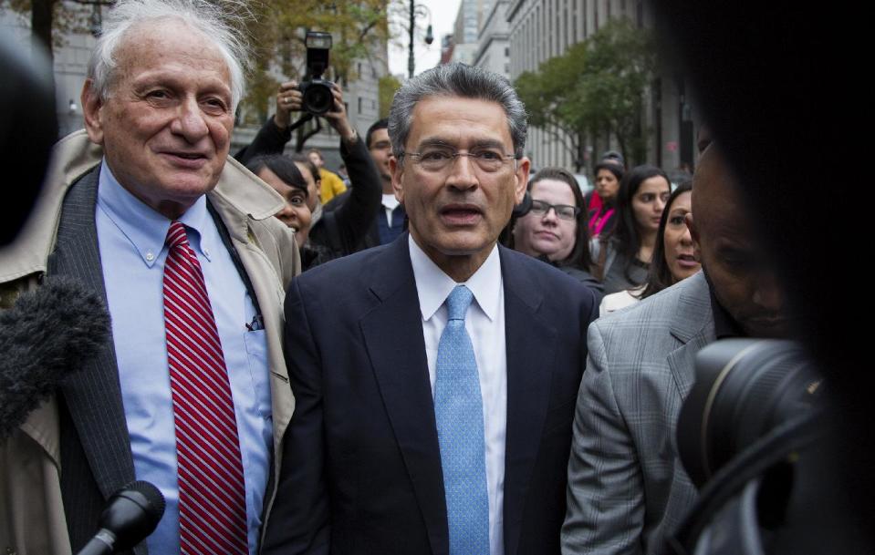 Rajat Gupta, center, leaves federal court in New York on Wednesday, Oct. 24, 2012 after the former Goldman Sachs and Procter & Gamble Co. board member was sentenced Wednesday to 2 years in prison for feeding inside information about board dealings with a billionaire hedge fund owner who was his friend. At left is Gupta's attorney, Gary Naftalis. (AP Photo/Craig Ruttle)