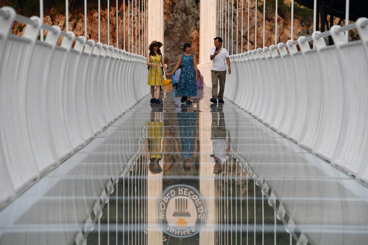 people walk on the Bach Long glass bridge in the Moc Chau district in Vietnam's Son La province