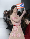 <p>Dayanara Torres walks the Stella Nolasco runway show carrying a Puerto Rican flag. (Photo: Getty Images) </p>