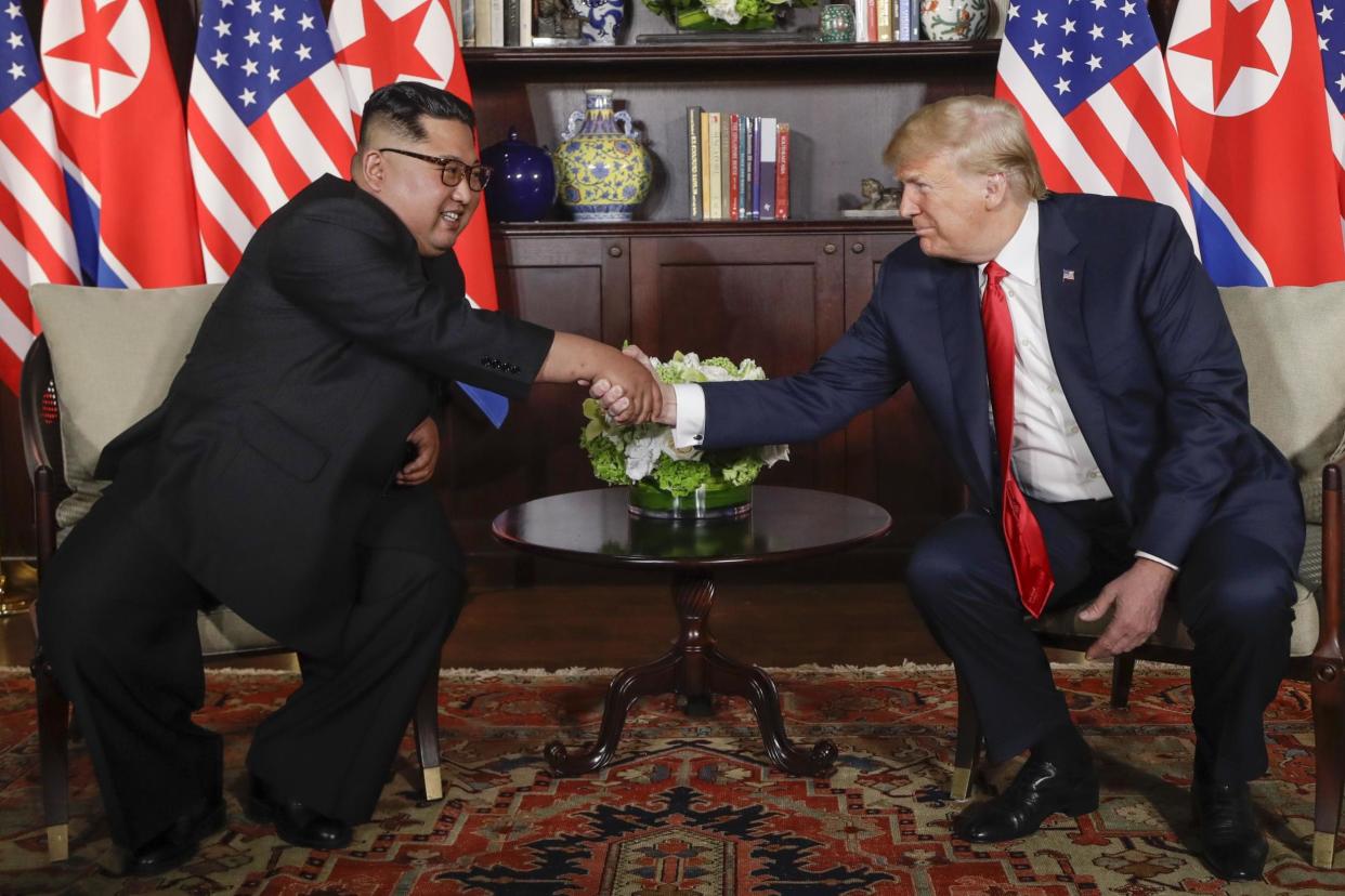 Donald Trump shakes hands with North Korea leader Kim Jong-un during their first meeting: AP