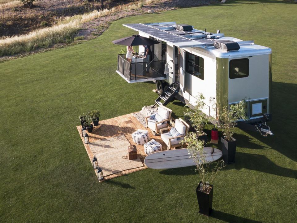 the 2022 Living Vehicle trailer outside on a patch of grass with an outdoor setup