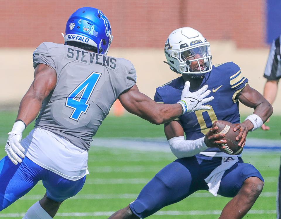 University of Akron quarterback DJ Irons eludes Buffalo defensive end Jyaire Stevens on Sept. 30 in Akron.