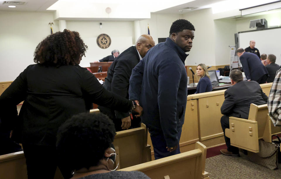 Adarius Carr, right, holds his sister Ashley Carr's hand as they leave the 396th Circuit Court after Aaron Dean was found guilty of manslaughter in the shooting death of Atatiana Jefferson, Thursday, Dec. 15, 2022, at the Tim Curry Criminal Justice Center in Fort Worth, Texas. Jefferson was fatally shot in Oct. 2019 when Dean, a former Fort Worth police officer, answered an open structure call at her residence. (Amanda McCoy/Fort Worth Star-Telegram via AP, Pool)