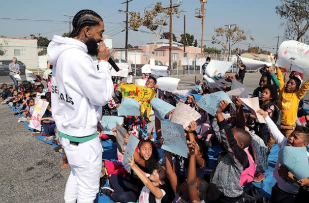 PHOTO: Rapper Nipsey Hussle speaks to kids after the opening of a basketball court, Oct. 22, 2018 in Los Angeles. Hussle partnered with Puma to refurbish the elementary school basketball court in south Los Angeles near where Nipsey grew up. (Jerritt Clark/Getty Images, FILE)