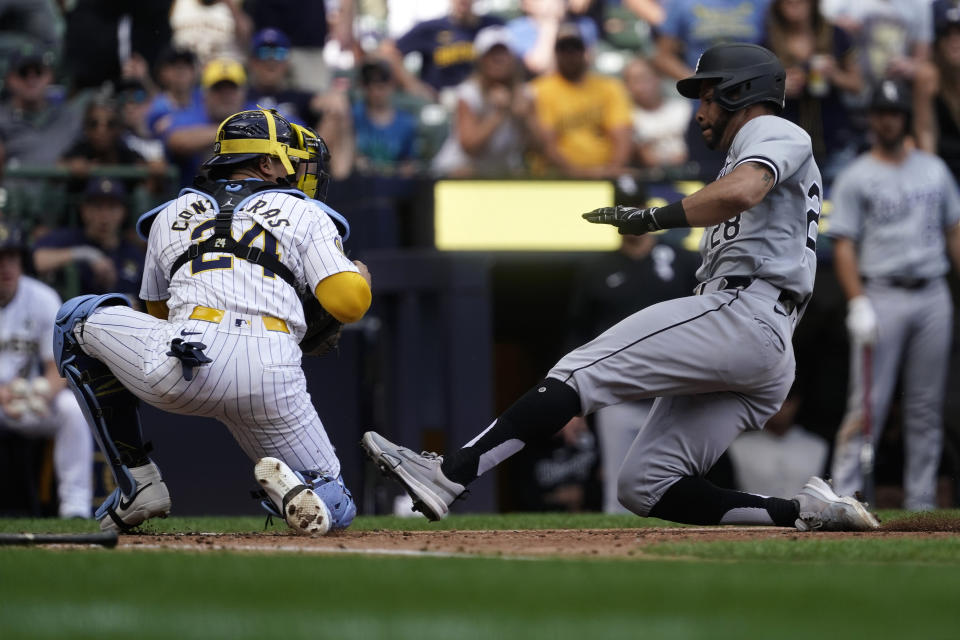 Chicago White Sox's Tommy Pham is tagged out at home by Milwaukee Brewers' William Contreras (24) during the eighth inning of a baseball game Sunday, June 2, 2024, in Milwaukee. (AP Photo/Aaron Gash)