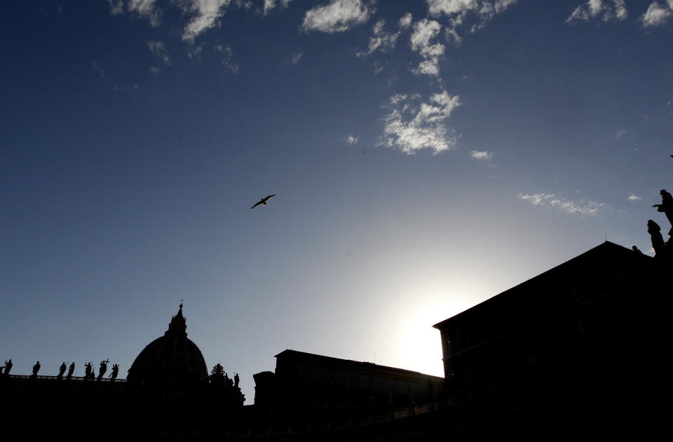 FILE - In this Thursday, June 29, 2017 file photo, St. Peter's Basilica is silhouetted at dusk, at the Vatican. Vatican prosecutors have alleged a jaw-dropping series of scandals in launching the biggest criminal trial in the Vatican’s modern history, which opens Tuesday in a modified courtroom in the Vatican Museums. The once-powerful cardinal and nine other people are accused of bleeding the Holy See of tens of millions of dollars in donations through bad investments, deals with shady money managers and apparent favors to friends and family. (AP Photo/Riccardo De Luca, File)