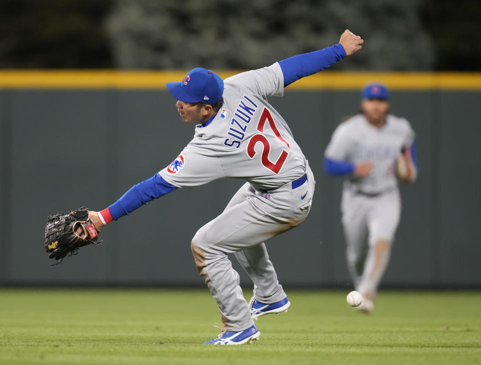 Chicago Cubs right fielder Seiya Suzuki misses a fly ball off the bat of Colorado Rockies' Elias Diaz in the fourth inning of a baseball game Thursday, April 14, 2022, in Denver. (AP Photo/David Zalubowski)