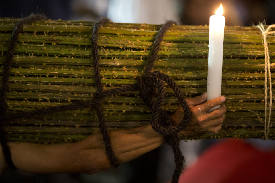 A penitent carries a load of thorny cacti during a Holy Week procession in Taxco, Mexico, late Thursday, April 17, 2014. Holy Week commemorates the last week of the earthly life of Jesus Christ, culminating in his crucifixion on Good Friday and his resurrection on Easter Sunday. (AP Photo/Rebecca Blackwell)