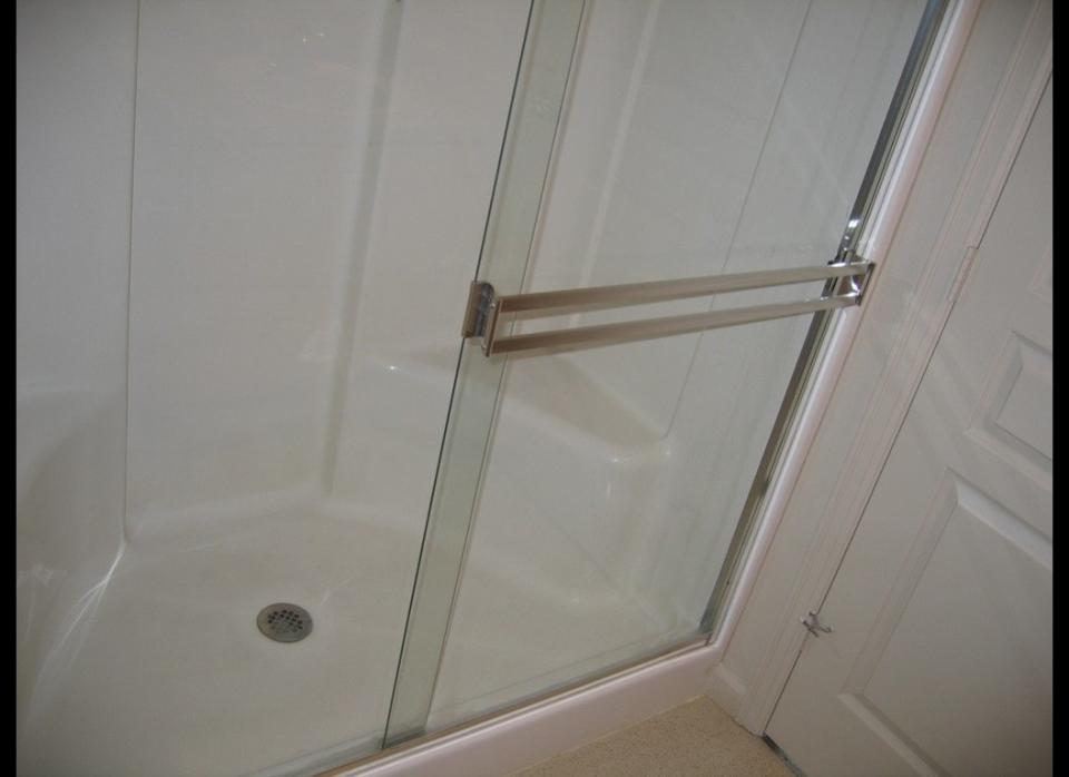 Nothing makes a shower door look worse than hard water stains...but they are pretty unavoidable. The good news: They aren't so difficult to remove. Using a sponge and pure-white vinegar, coat the shower door and repeat this as the vinegar dries, so the door is constantly saturated in wet vinegar for at least five minutes. After that, the stains and scum should dissipate. If not, repeat the process. Afterward, rinse the door with warm water.     For the full tutorial head over to <a href="http://tlc.howstuffworks.com/home/shower-door-cleaning-soap-scum-and-hard-water-stains1.htm" target="_hplink">How Stuff Works</a>.   