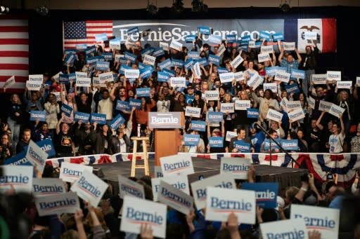 Supporters of Democratic presidential candidate Bernie Sanders wait for results at his caucus night watch party in Des Moines, Iowa