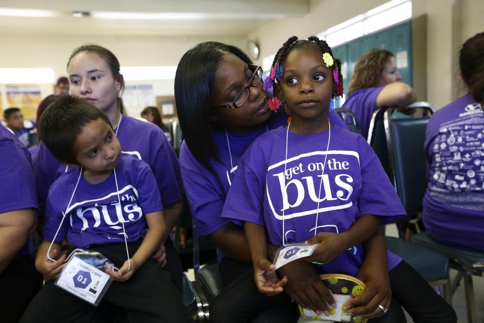 Tyla Gregory and her mother wait to get visitors passes during a "Get On the Bus" visiting day to Folsom State Prison