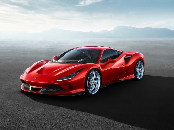 a red Ferrari car sitting on a flat surface