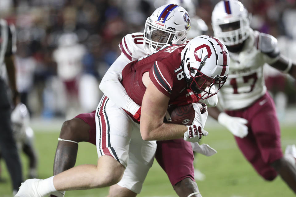 South Carolina tight end Austin Stogner (18) carries South Carolina State defensive back Duane Nichols (10) into the end zone on a 15-yard touchdown reception during the second half of an NCAA college football game Thursday, Sept. 29, 2022, in Columbia, S.C. (AP Photo/Artie Walker Jr.)