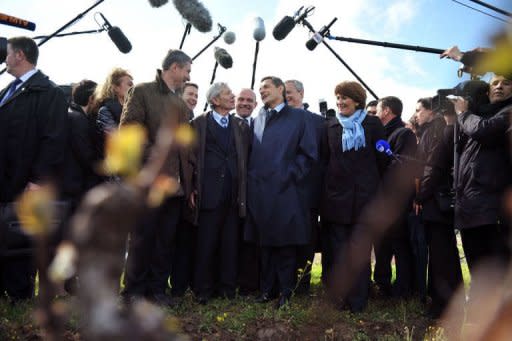 France's incumbent president and candidate for the 2012 presidential election, Nicolas Sarkozy (C) talks with wine growers in Vouvray. He went gunning for more than six million far-right votes in a bid to catch up with Socialist Francois Hollande who took the lead in round one of the French presidential election