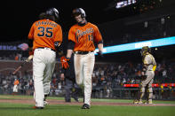 San Francisco Giants' Austin Slater (13) gets a congratulatory handshake from Brandon Crawford (35) after hitting a solo home run against the San Diego Padres during the seventh inning of a baseball game Friday, May 7, 2021, in San Francisco. (AP Photo/D. Ross Cameron)