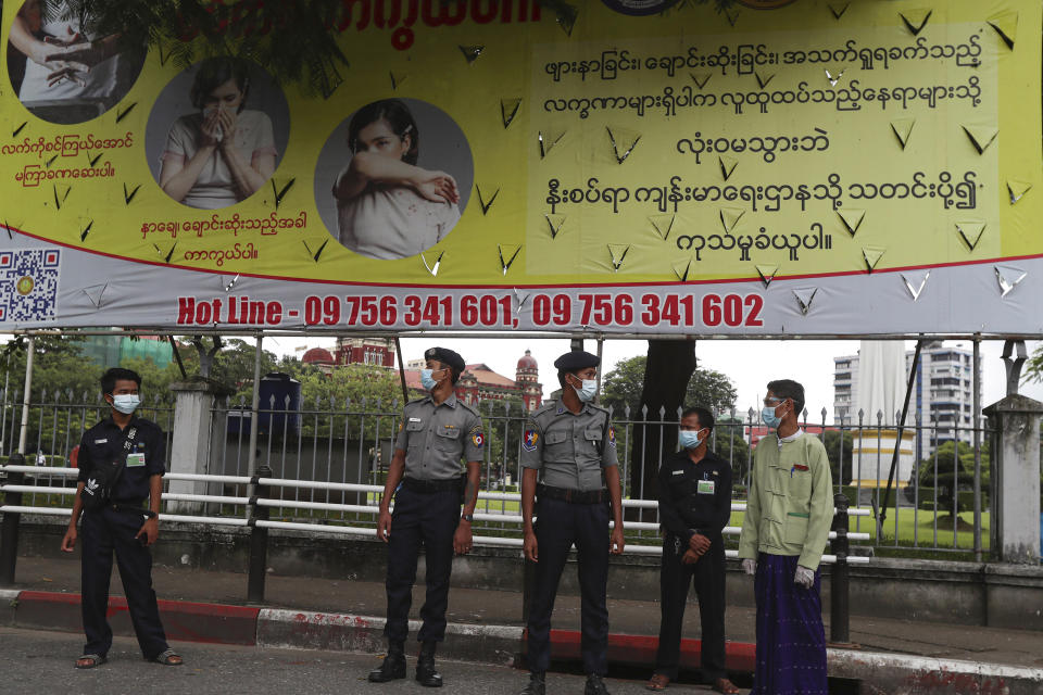 Police officers and officials prepare to check passengers of vehicles for documents to prove they are allowed to travel from one township to another amidst coronavirus restrictions imposed in Yangon, Monday, Sept. 28, 2020, in Yangon, Myanmar. The total number of coronavirus cases in Myanmar went over 10,000 during the weekend. (AP Photo/Thein Zaw)