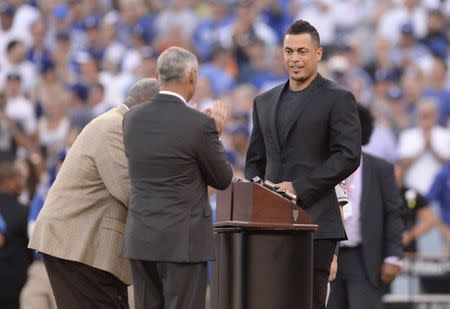 FILE PHOTO: Oct 25, 2017; Los Angeles, CA, USA; Miami Marlins outfielder Giancarlo Stanton is greeted by MLB commissioner Rob Manfred and Hank Aaron before game two of the 2017 World Series between the Los Angeles Dodgers and the Houston Astros at Dodger Stadium. Gary A. Vasquez-USA TODAY Sports