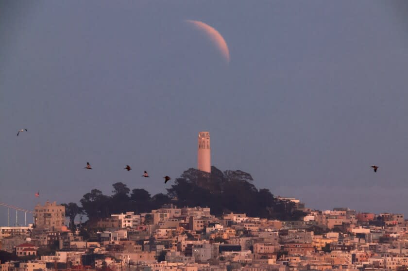 SAUSALITO, CALIFORNIA - MAY 15: A partially-eclipsed Blood Moon rises over San Francisco's Coit Tower on May 15, 2022 in Sausalito, California. (Photo by Justin Sullivan/Getty Images)